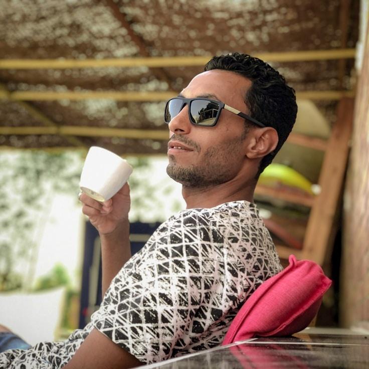 Kaveri Mehta, Lead Design Curator at DuskHarborDock, reviewing corporate floral arrangements